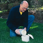 Man applying RootX using septic system drain line